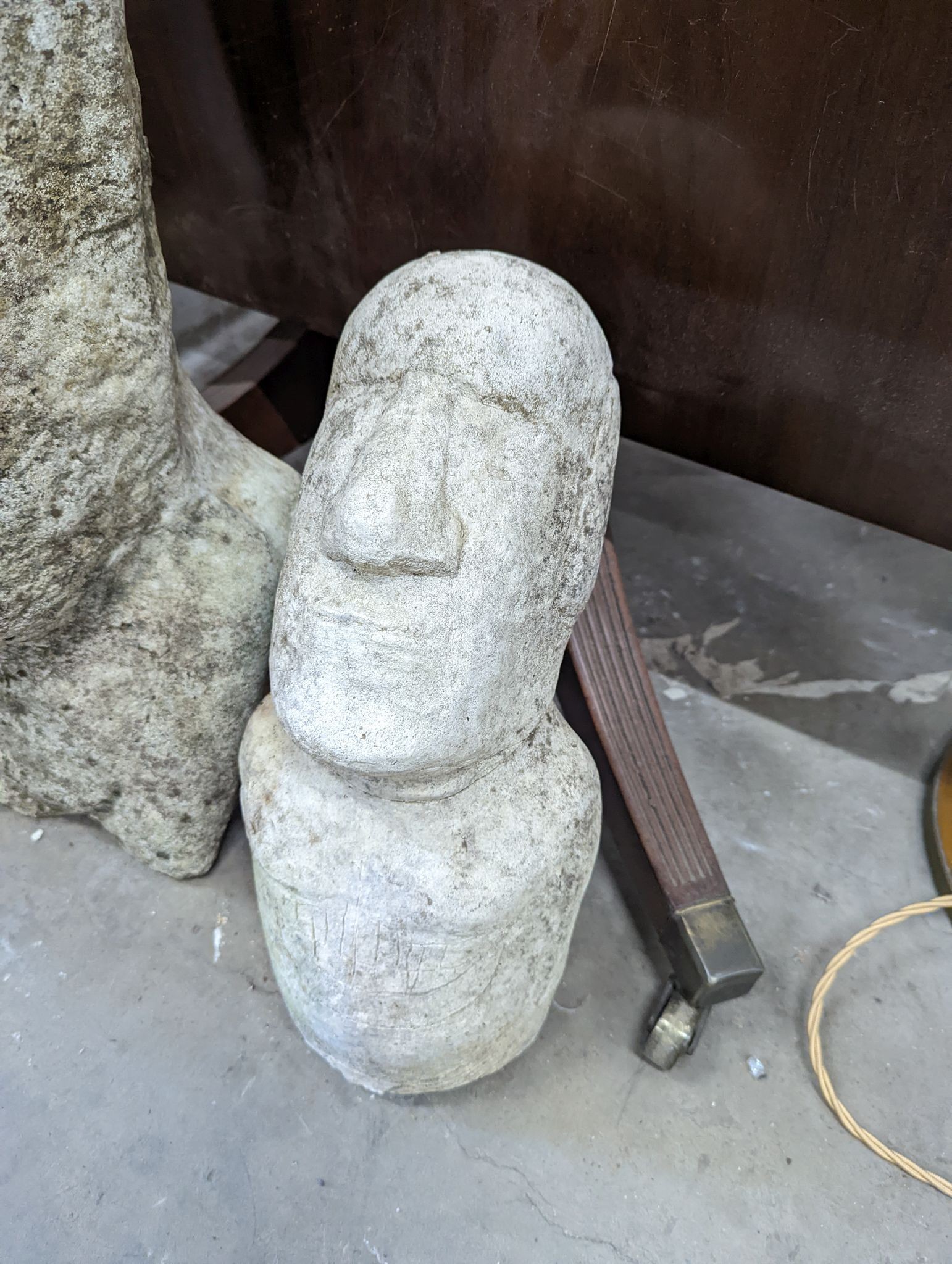 Three reconstituted stone Easter Island style garden ornaments, largest height 58cm